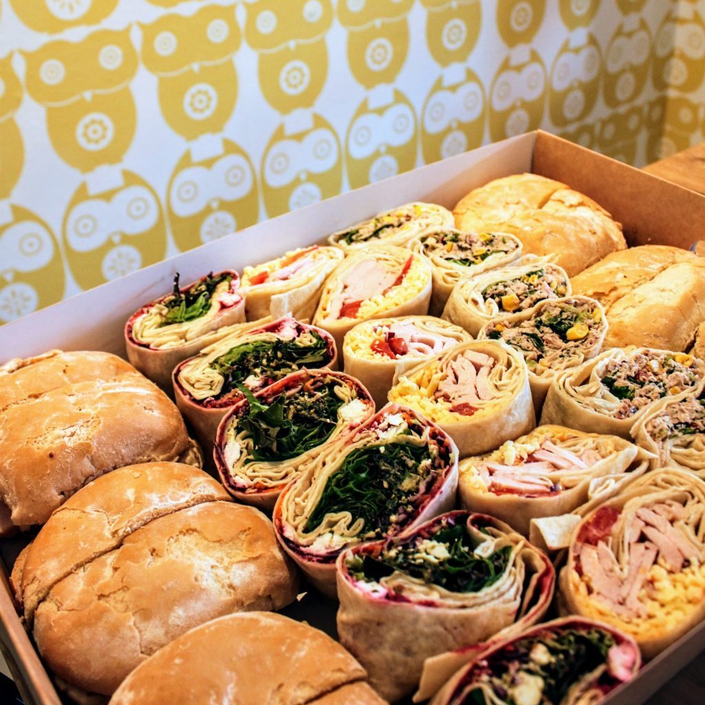 A box of wraps and rolls against the owl wallpaper.